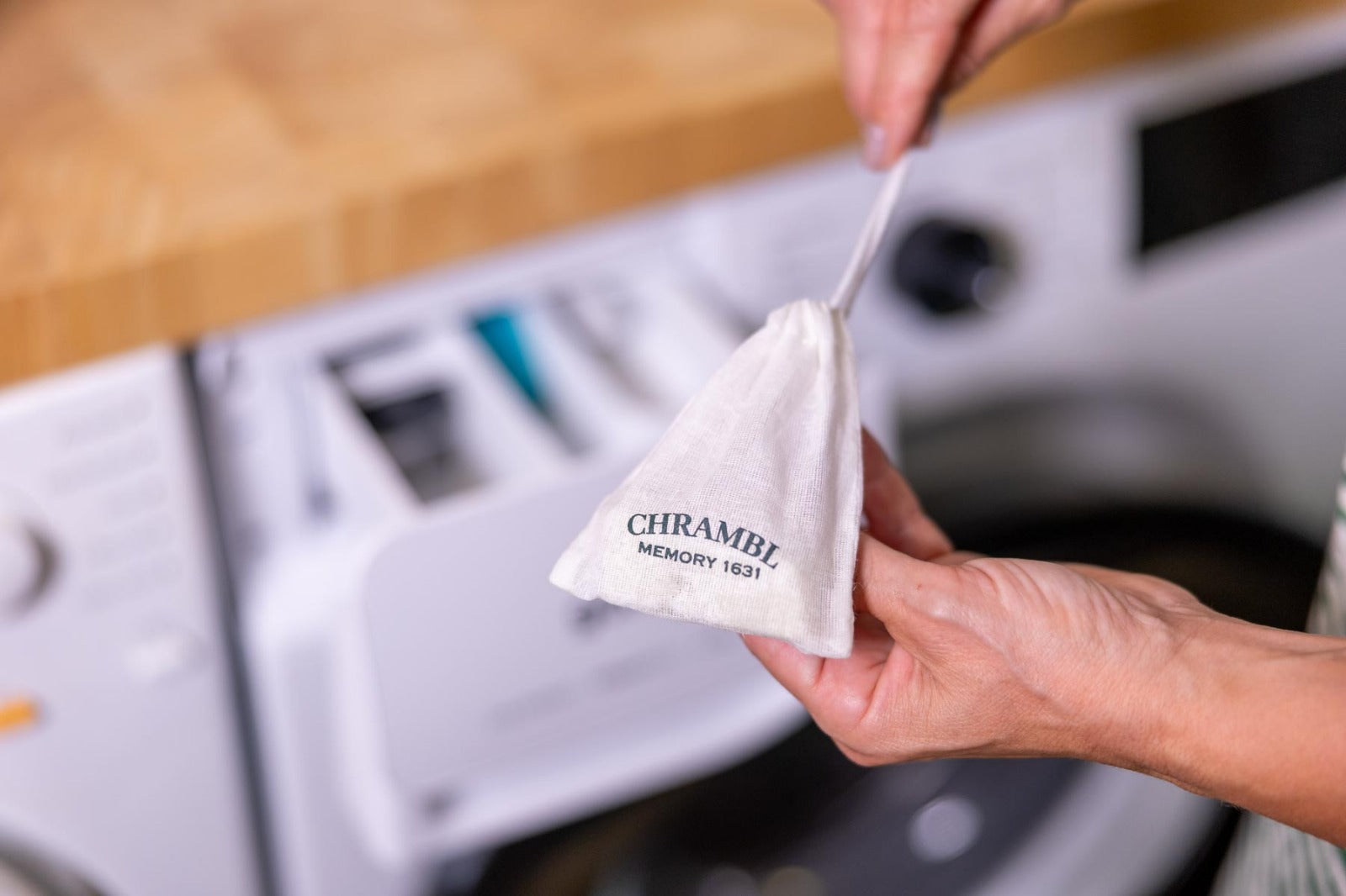 Filterbeutel und Produkt vor Waschmaschine und Dosierlade